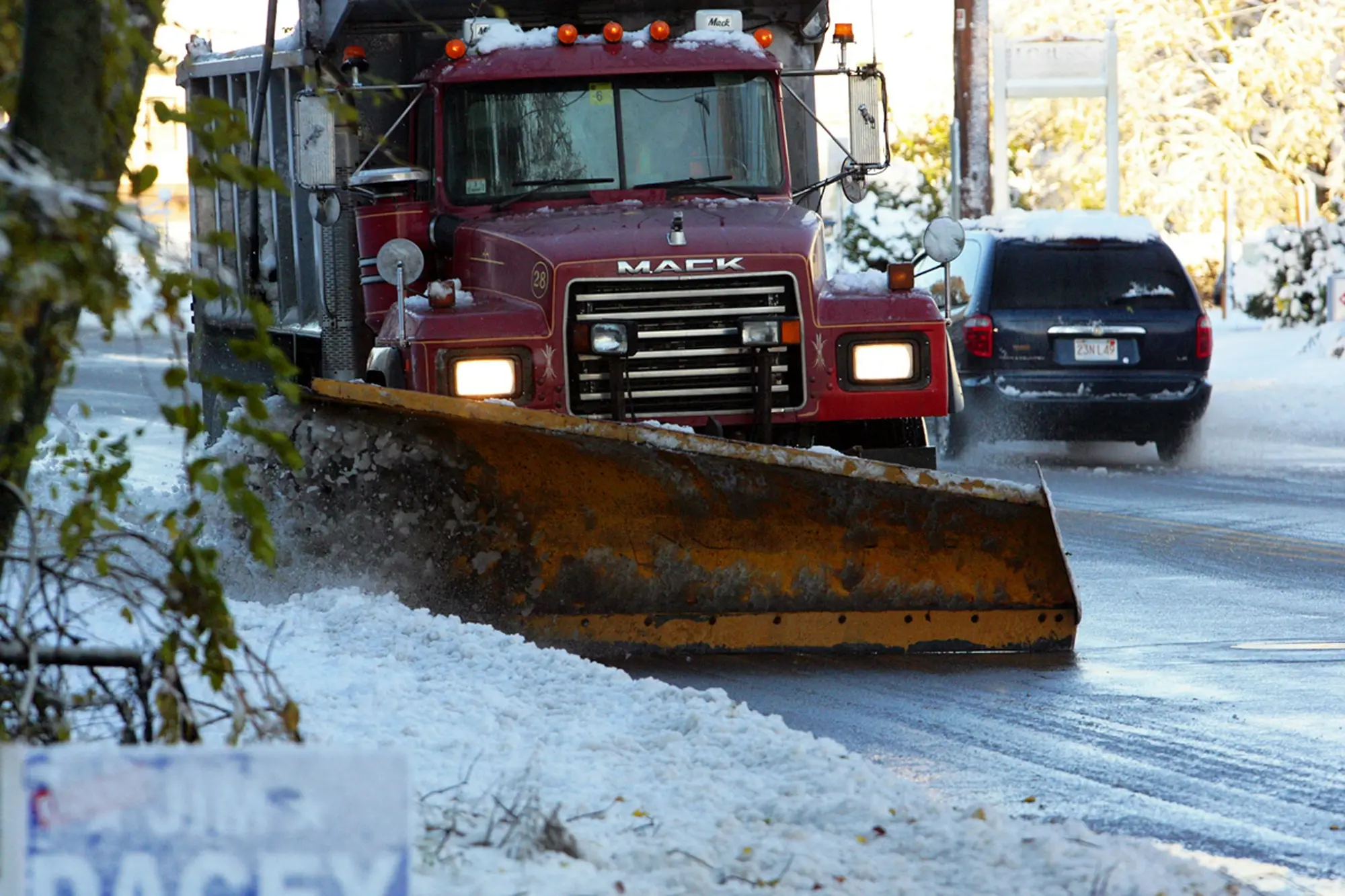 Snow plow clearing a snow-covered road