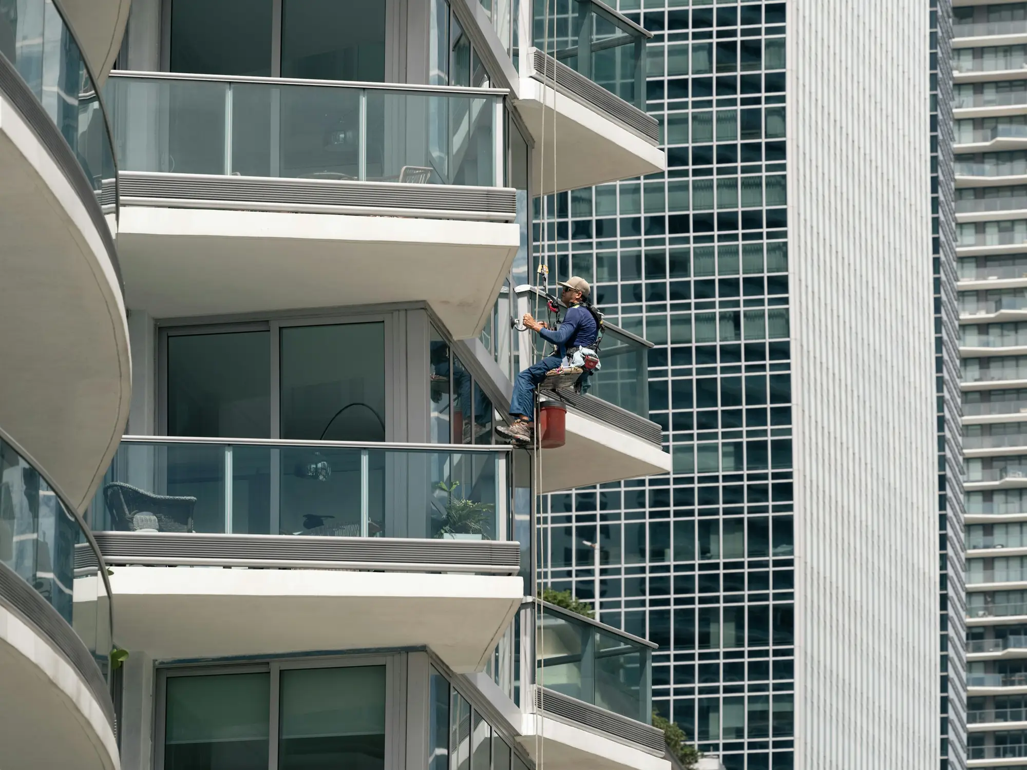 Window cleaner working on the glass exterior of a high-rise